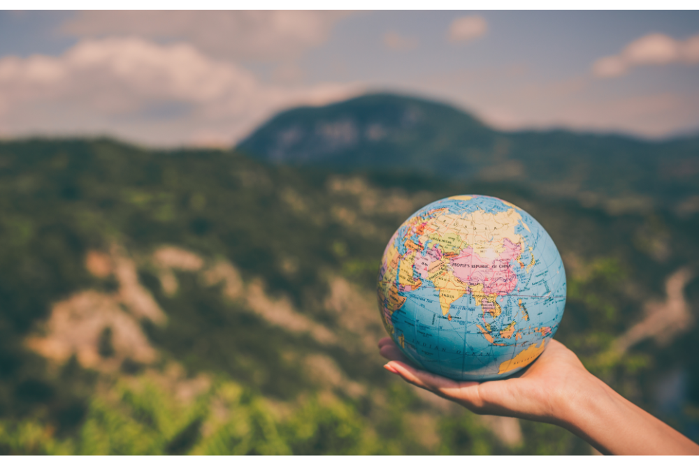 a person holding a globe, representing global digital media company