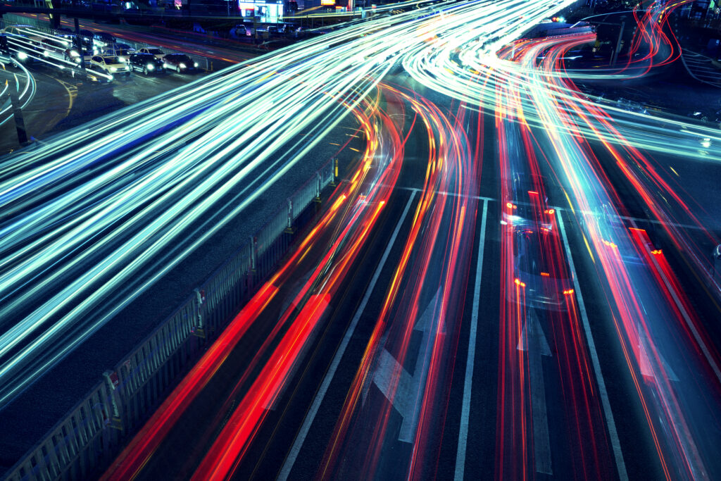 Car light trails indicating speed