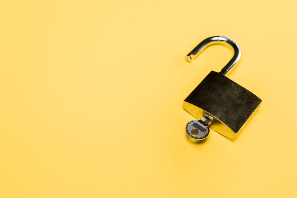 An open lock with the key in it 