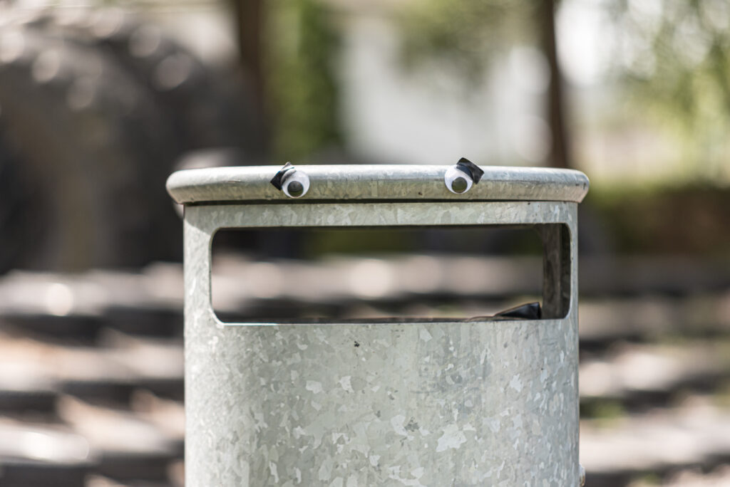 A bin with googly eyes