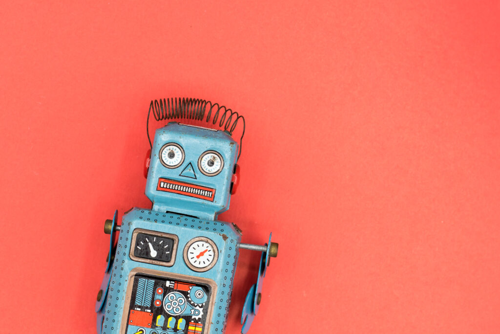 A toy robot on a red background