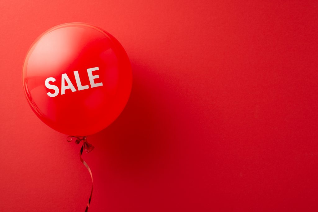 A red sale balloon on a red background